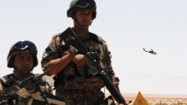 Jordanian soldiers stand guard near the Jordanian Karameh border crossing at the Jordanian-Iraqi border