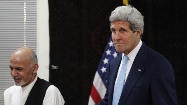 U.S. Secretary of State Kerry escorts Afghanistan's presidential candidate Ghani out of a photo opportunity before a meeting at the U.S. embassy in Kabul