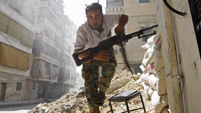 A Free Syrian Army fighter takes cover during clashes with Syrian Army in the Salaheddine neighbourhood of central Aleppo