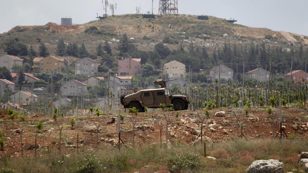 Israeli soldiers patrol near the Lebanese-Israeli border as seen from the southern Lebanese village of Mays Al-Jabal