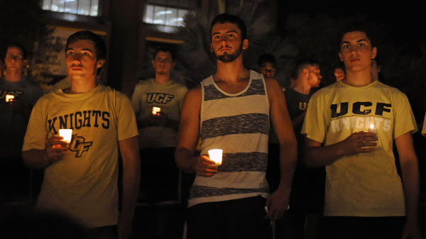 Students hold candles during a vigil honoring U.S. journalist Steven Sotloff  at the Reflection Pool on the campus of the University of Central Florida in Orlando